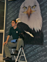 Guy holding a bald eagle on his arm