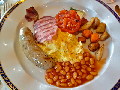 english breakfast with potato, beans, sausage, eggs and ham