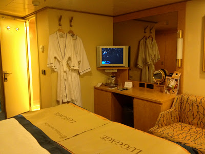Interior stateroom vanity area with TV and mirror