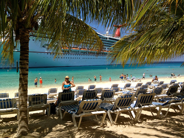 Beach with lounge chairs and palm trees at Grand Turk