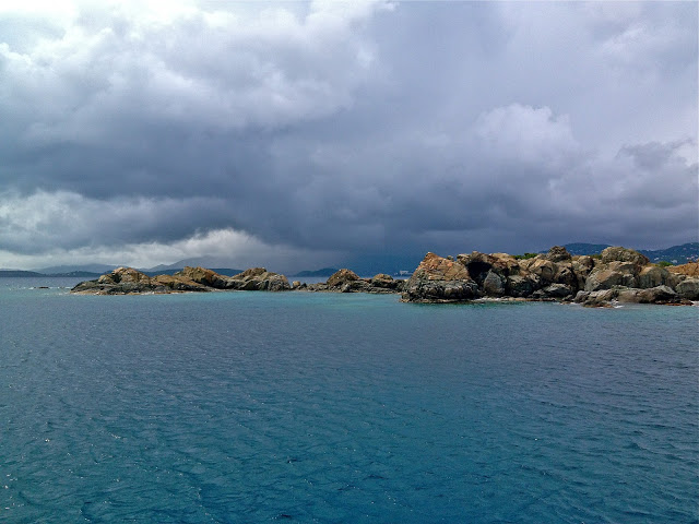 Rain clouds over the ocean and rocks