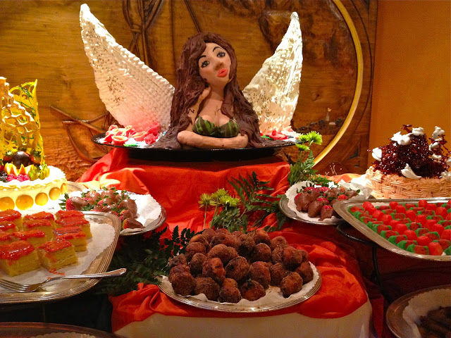 Dessert buffet with an angel marzipan sculture and lots of desserts