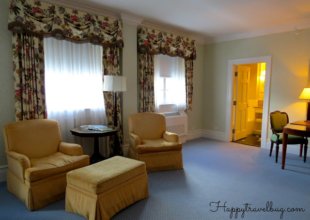 Seating, desk and bathroom entrance in our Greenbrier Hotel room