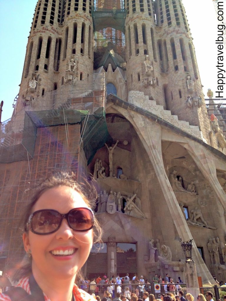 Happy travel bug at La Sagrada Familia in Barcelona, Spain