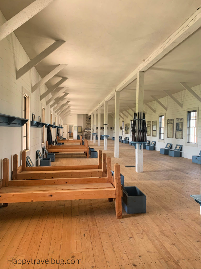 Inside the calvary barracks with beds all lined up