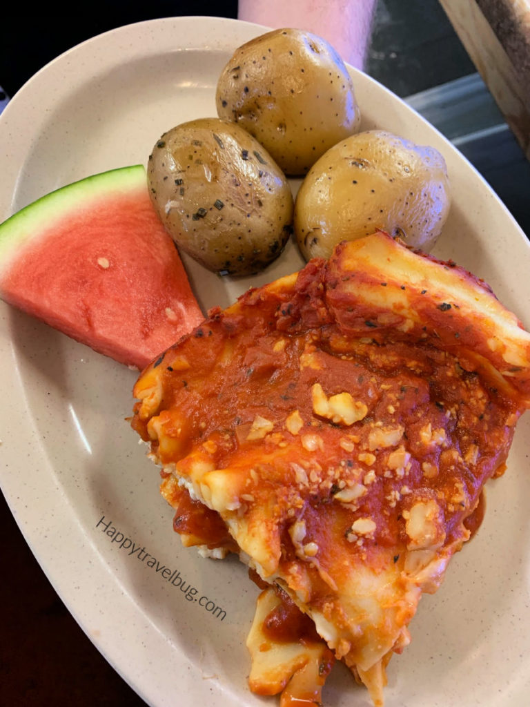 lasagna with potatoes and a watermelon slice