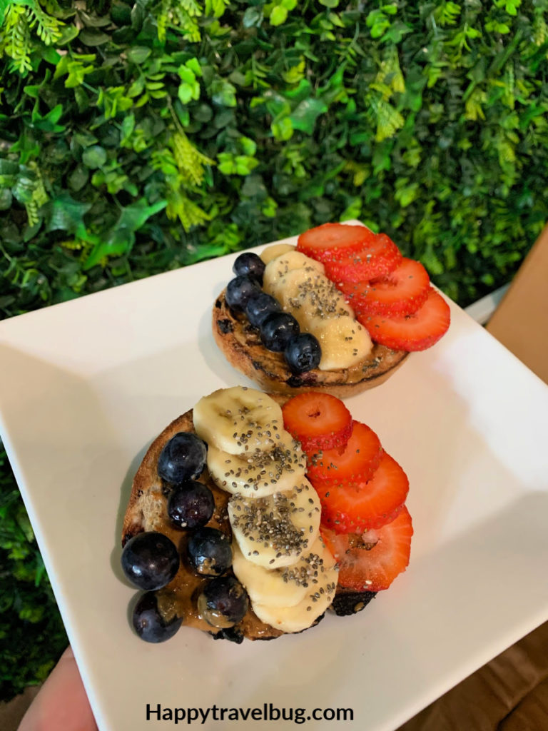 bagel with blueberries, bananas, and strawberries on it