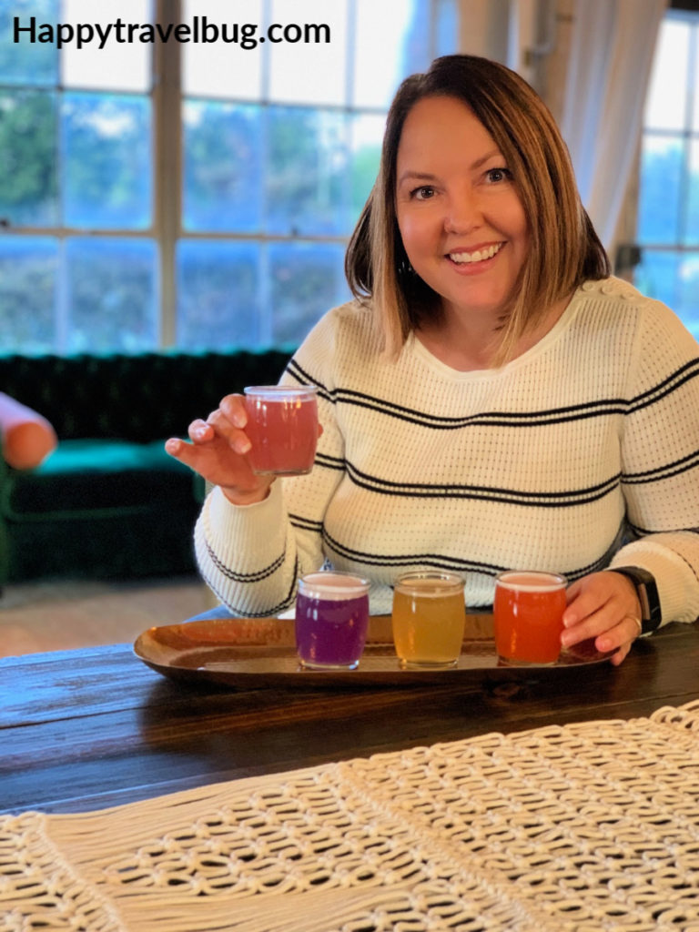 woman drinking four different flavors of kombucha