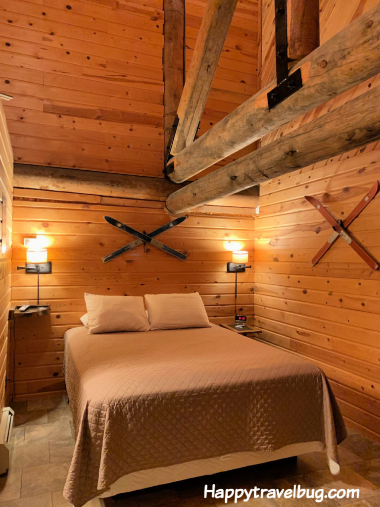 Log cabin bedroom with skis on the wall