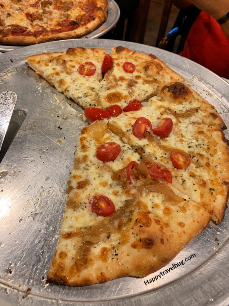 Pizza with cheese, cooked onions and tomatoes 