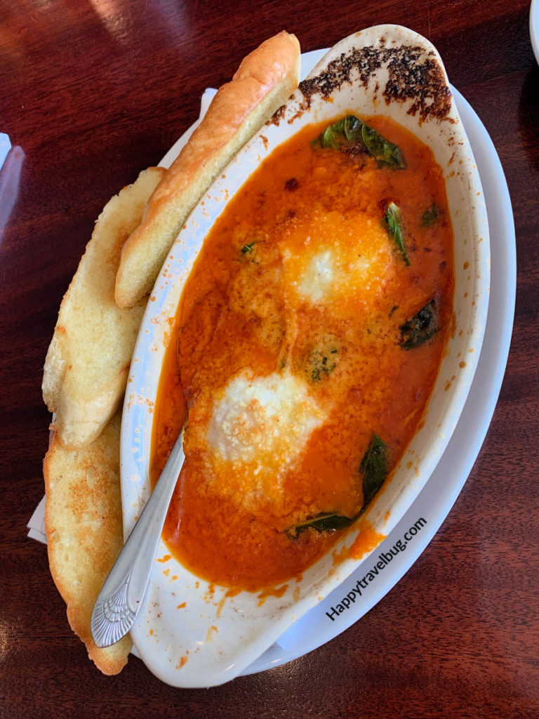 Eggs in a spicy tomato sauce with bread on the side for dipping