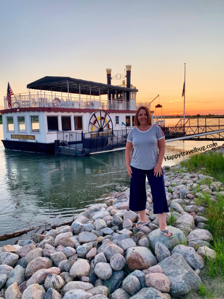 Woman standing in front of a riverboat on the Missouri River
