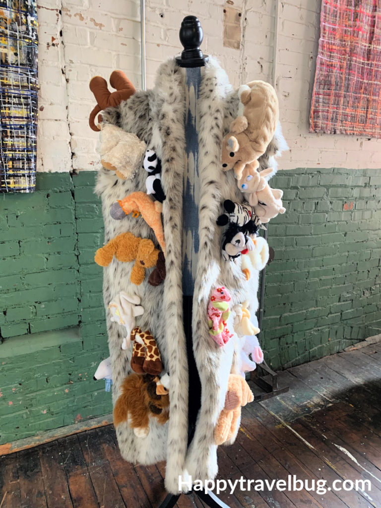 FAke furr coat with stuffed animals on it