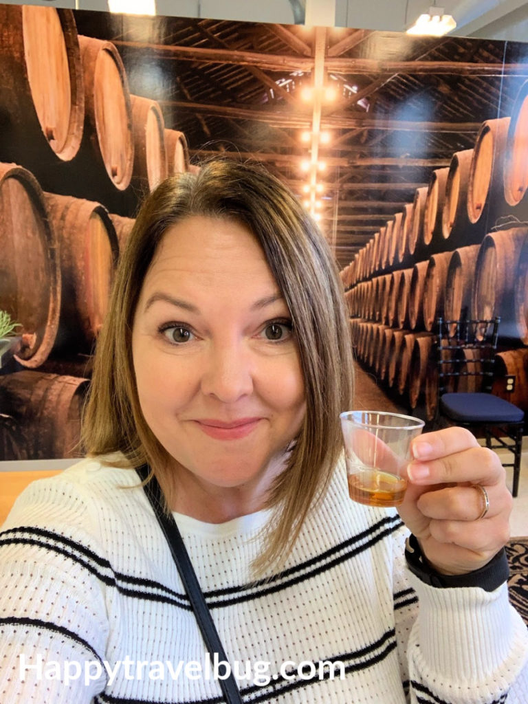 Woman drinking bourbon whiskey sample