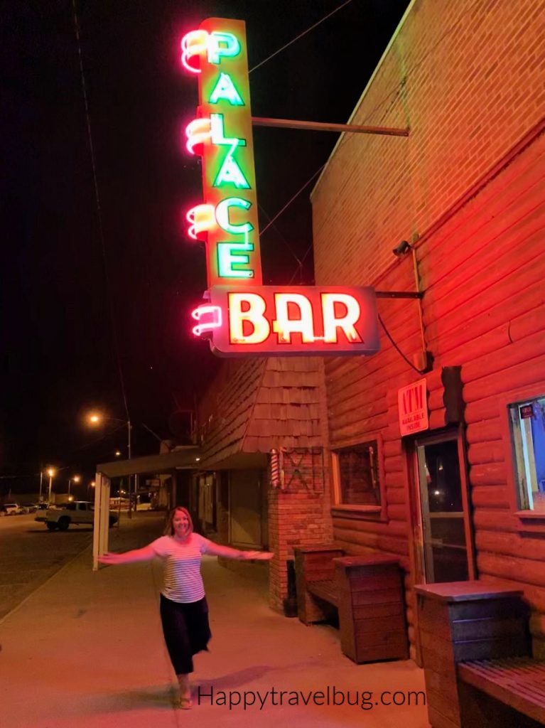 Neon sign for Palace Bar on a building